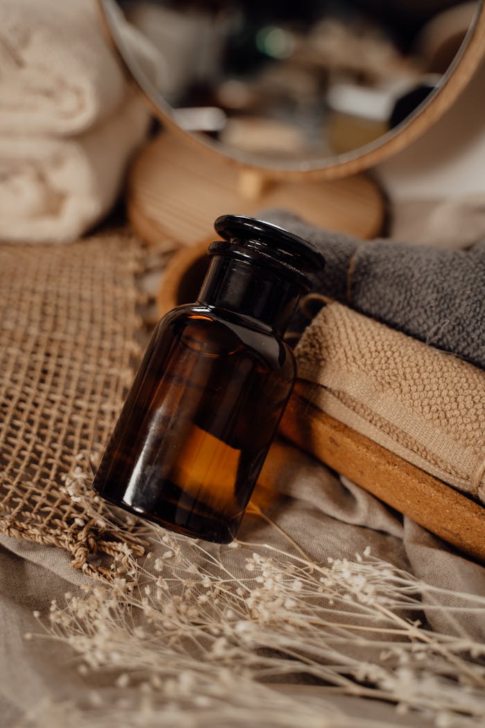 A cozy, rustic scene featuring a brown glass bottle for aromatherapy and pampering.